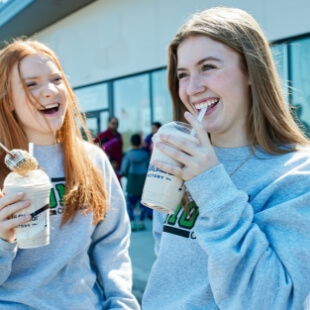 girls drinking milkshake outside