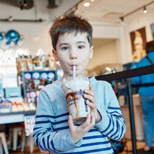little boy drinking milkshake