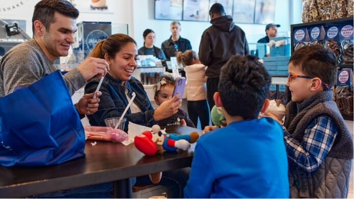 family at a table drinking milkshakes