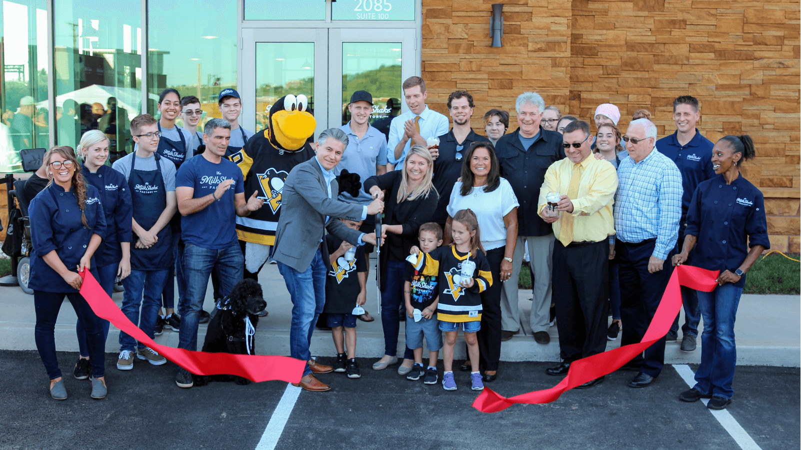 group of people cutting rope at new store