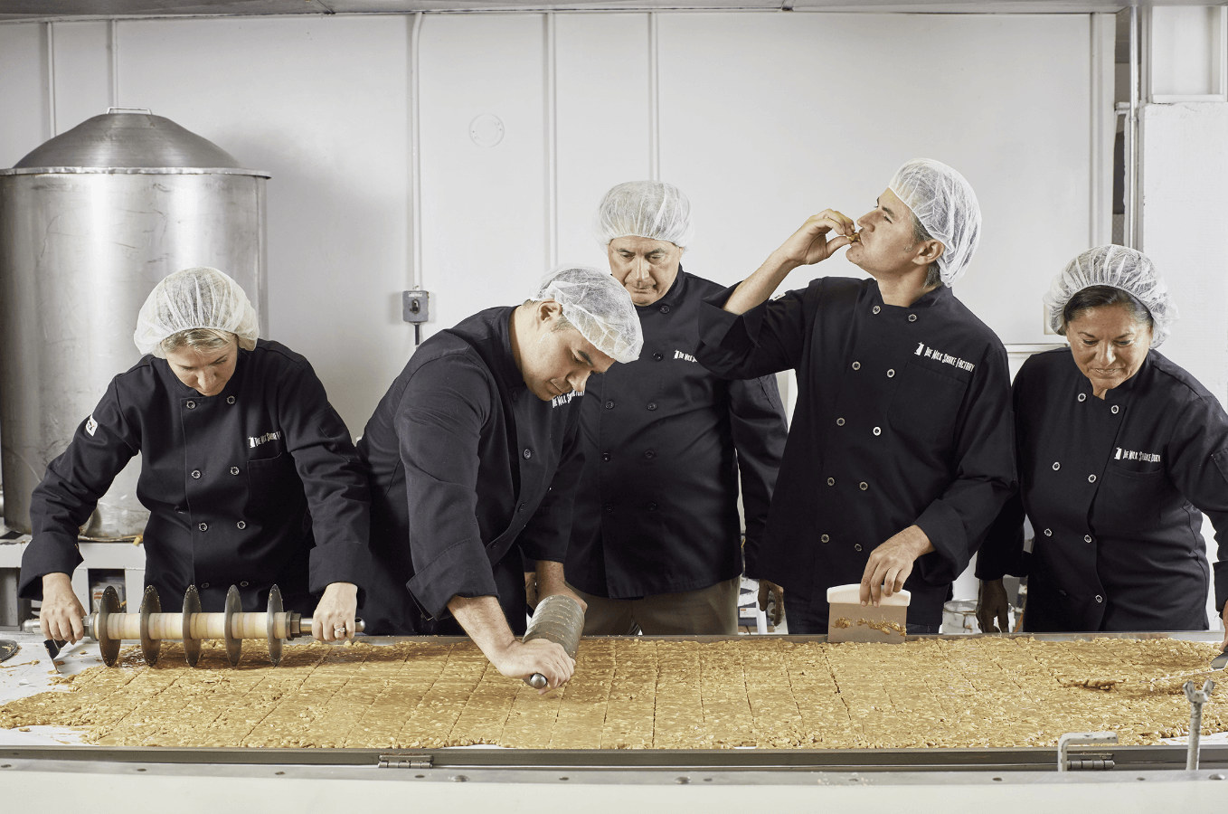group of people cutting chocolate