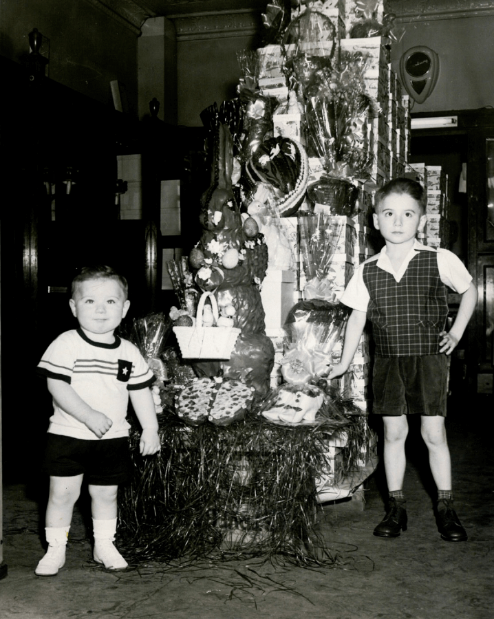 children standing with chocolate bunny