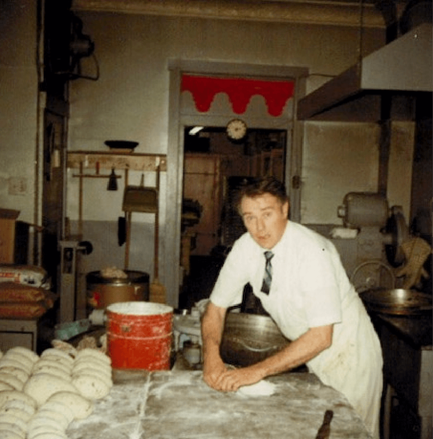 man mixing dough in kitchen