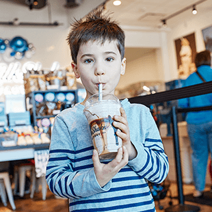 little boy drinking milkshake