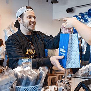 man handing bag to customer