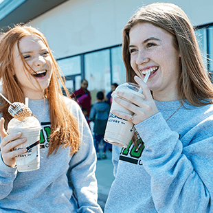 girls drinking milkshake outside