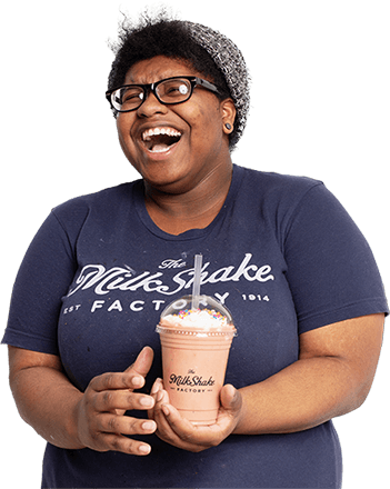 employee laughing and holding milkshake