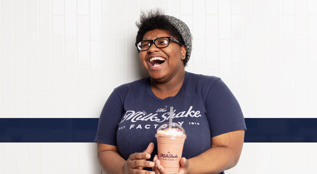 Customer smiling at a MilkShake Factory Dessert Franchise.
