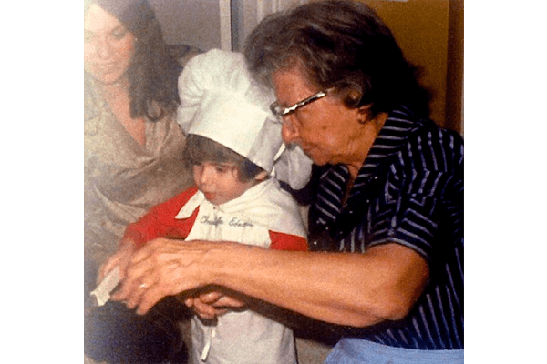 woman and boy cutting cookie