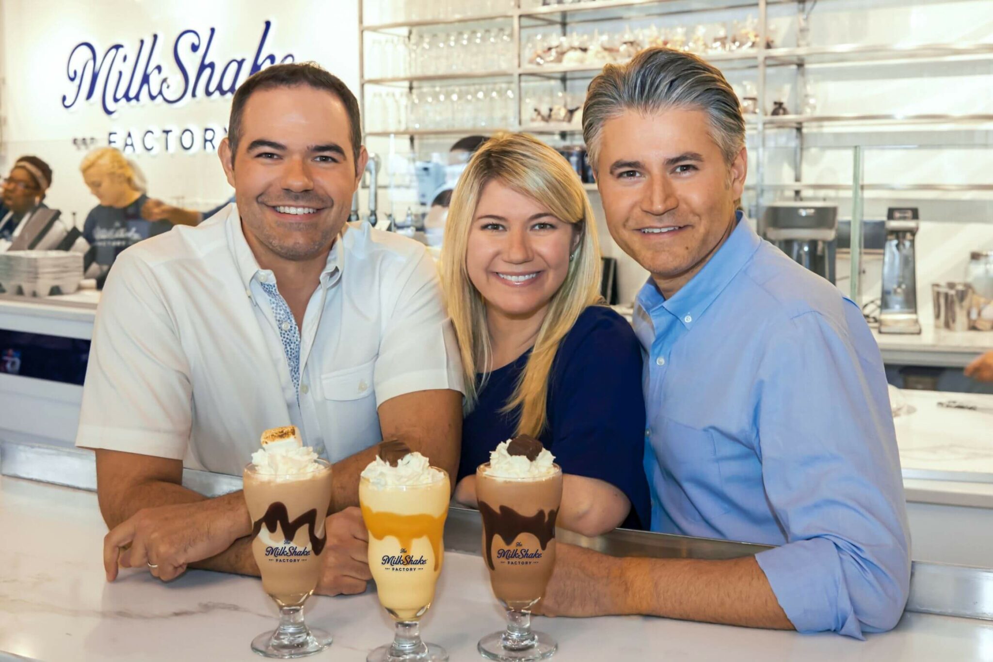 The founding team of MilkShake Factory, a chocolate and dessert franchise, smiling.