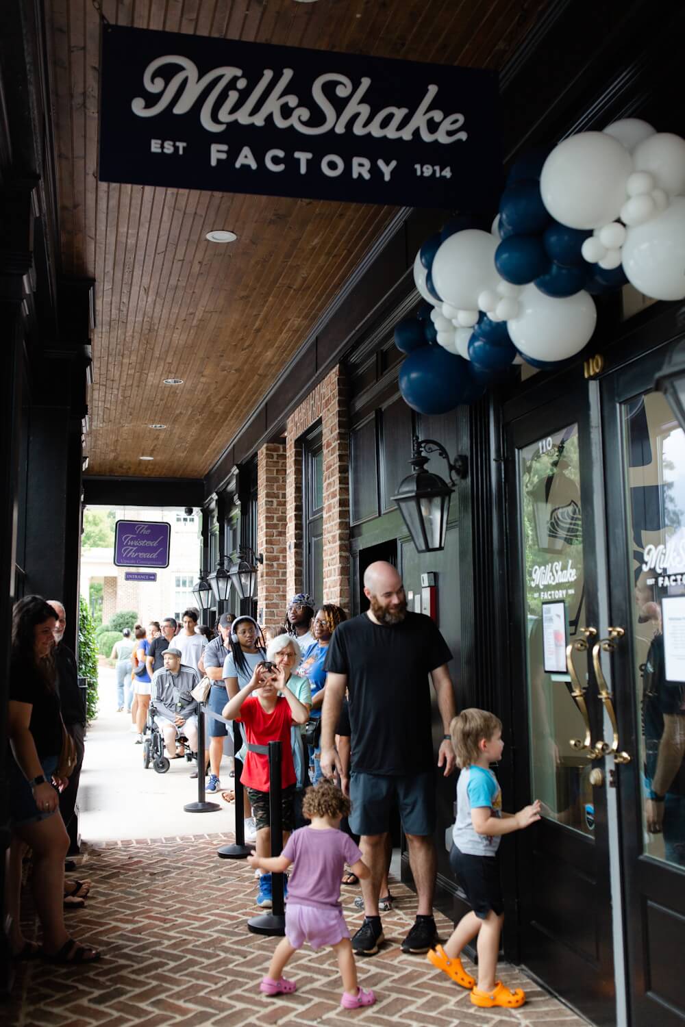 Milton Grand Opening happy customers line outside door